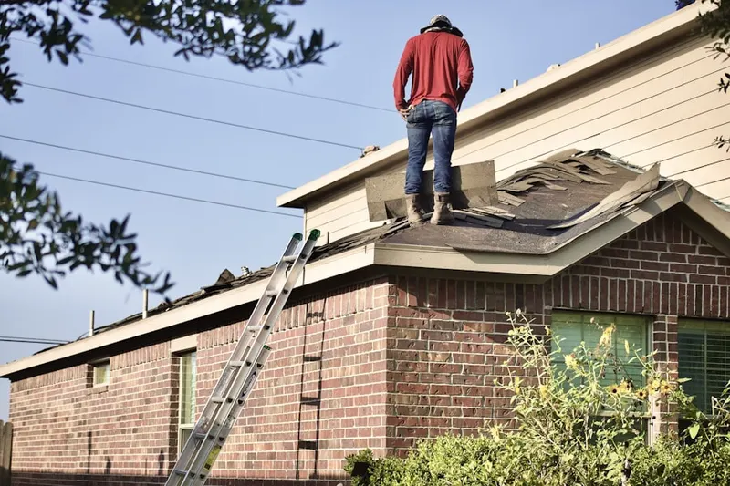 Professional roofer working on a residential roof in Flonellis